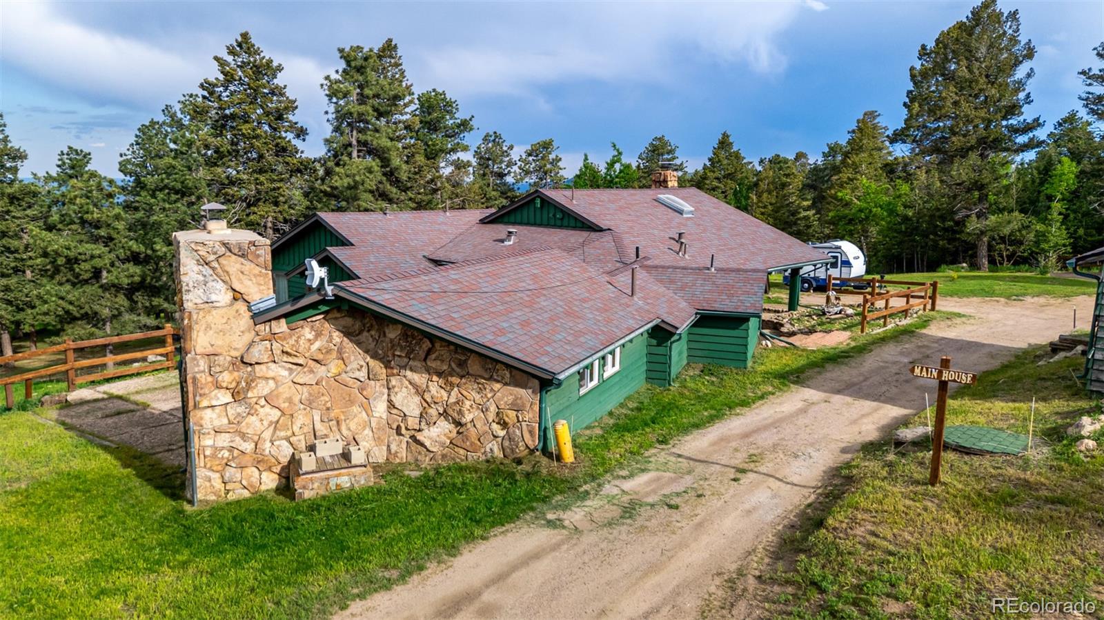 8537 Doubleheader Ranch Road Morrison, CO 80465 - Photo 40 of 48 an aerial view of a house with garden