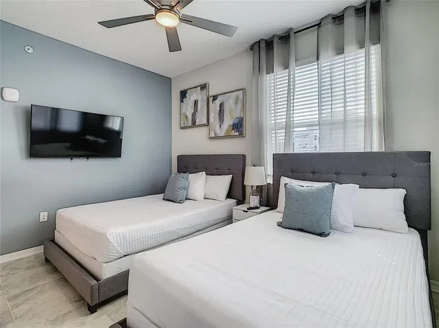 a bedroom with a large bed and a flat screen tv