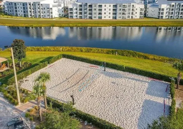 a view of swimming pool with outdoor seating and lake view