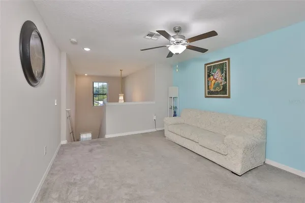a spacious bedroom with a bed and a chandelier