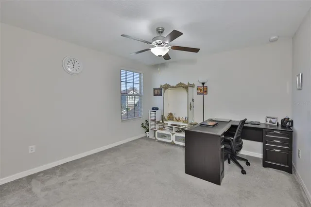 a view of a workspace with furniture and a window