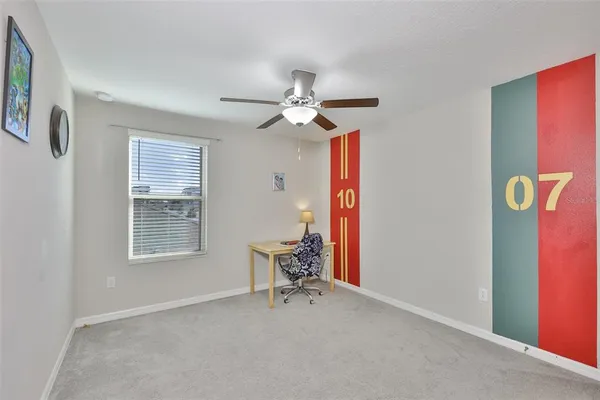 a view of a livingroom with a window and a chair