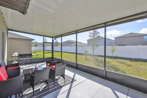 a living room with furniture and a floor to ceiling window