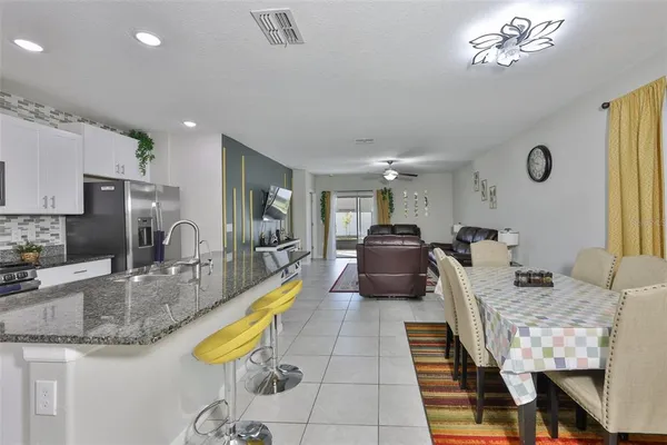 a kitchen with sink cabinets and dining table