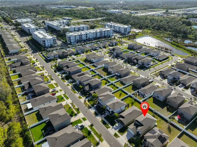 an aerial view of multiple houses with yard