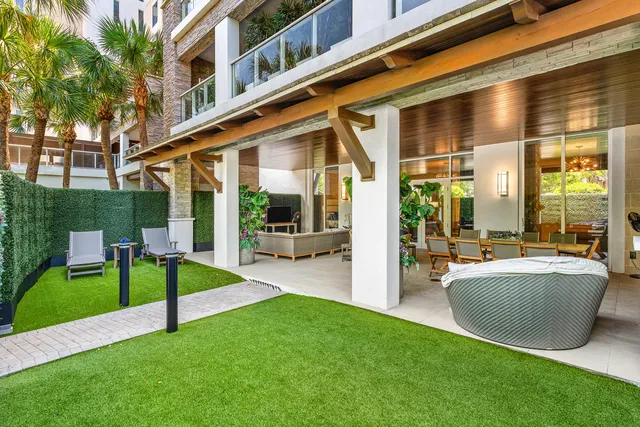 a view of a patio with couches and table and chairs with potted plants