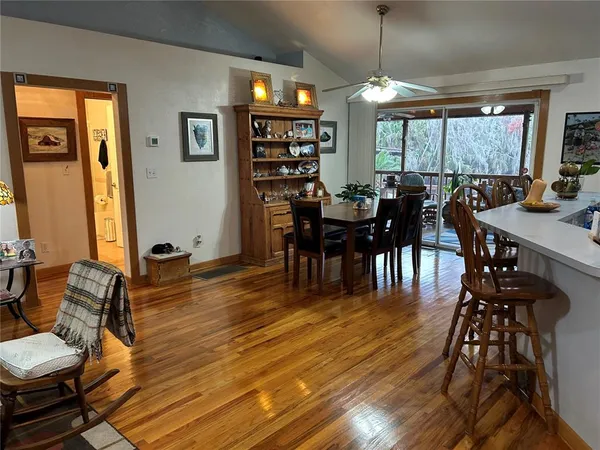 a view of a dining room with furniture window and wooden floor