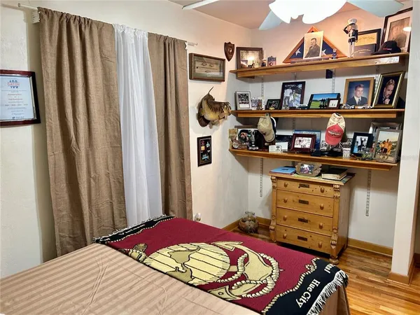 a bedroom with a bed and closet with wooden floor