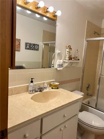 a bathroom with a sink a toilet and mirror
