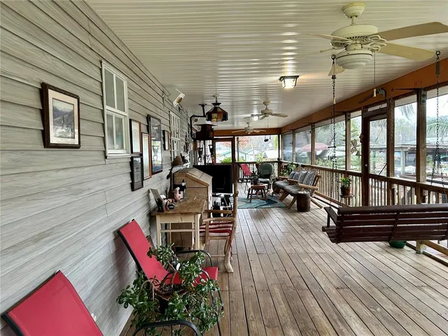 a view of a patio with chairs and potted plants