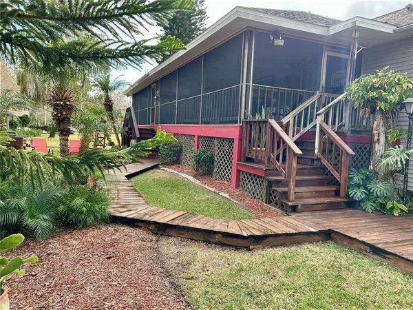 a room with wooden floors and outdoor seating