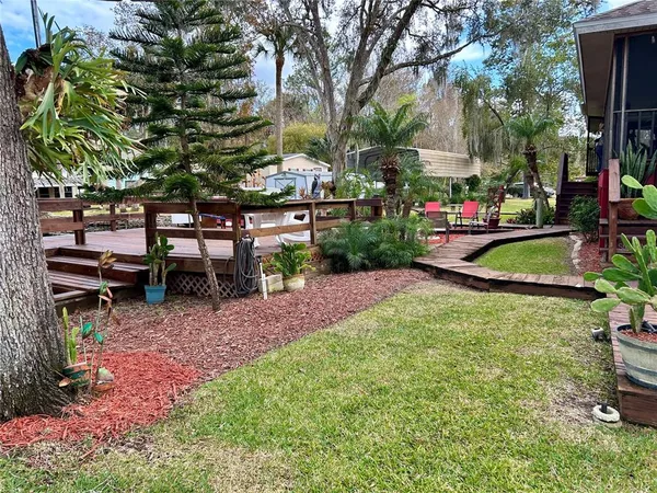 a view of backyard with barbeque grill and wooden floor