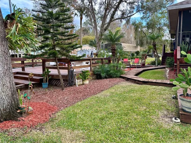 a view of backyard with barbeque grill and wooden floor