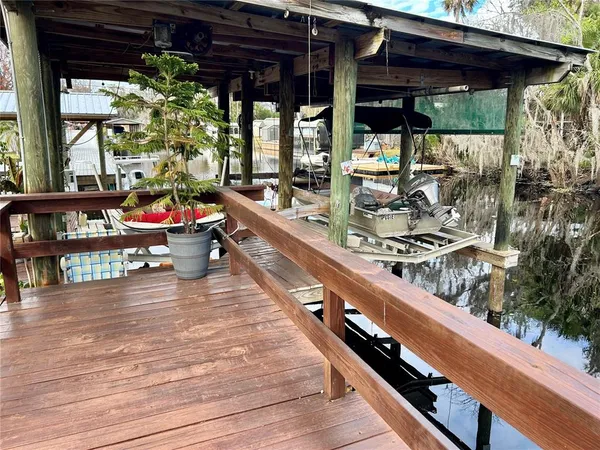 a view of roof deck with dining table and chairs with wooden floor