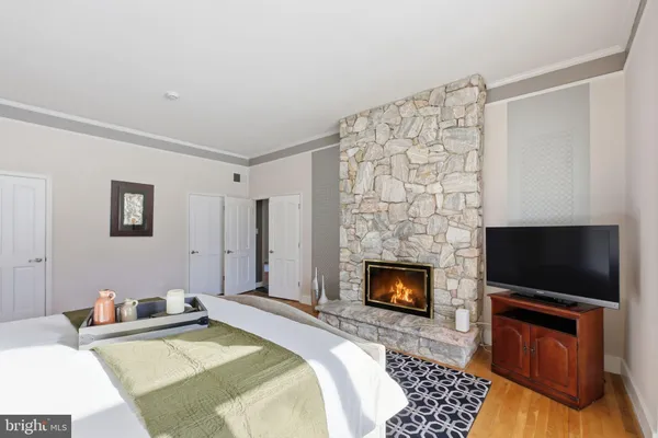 a bedroom with furniture and wooden floor