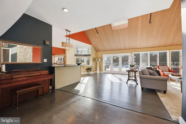 a living room with fireplace furniture and a large window