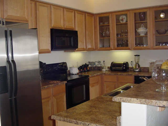 4488 East Thomas Road, Unit 3040 Phoenix, AZ 85018 - Photo 1 of 7 Kitchen w/ Refrigerator + Large W/D