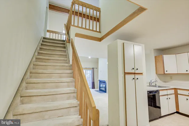 a view of a hallway with wooden floor and entryway