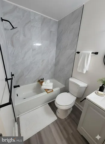 an empty room with a chandelier fan and closet area