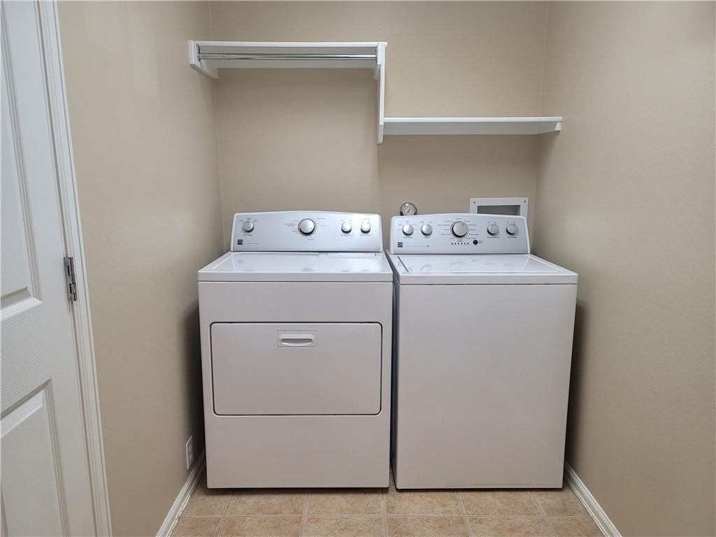 208 Hummingbird Lane Leander, TX 78641 - Photo 20 of 25 Functional laundry room equipped with essential appliances and convenient shelving.