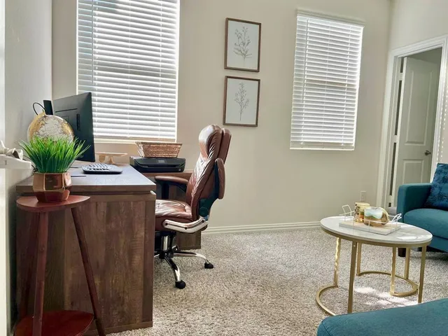 a view of a workspace with furniture