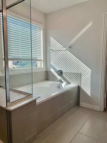 a spacious bathroom with a mirror sink and vanity