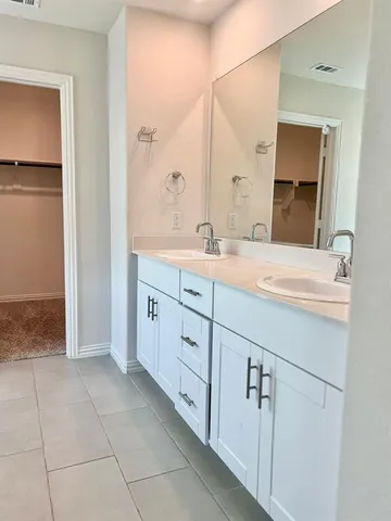 a bathroom with a sink a mirror and a window