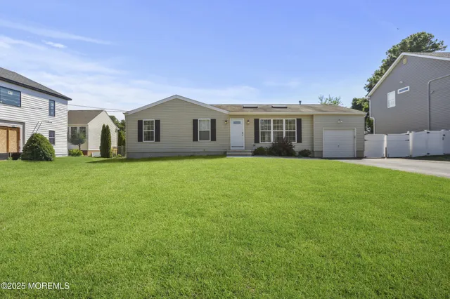 a front view of house with yard and green space