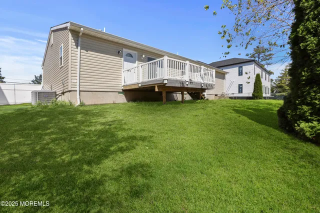 a view of house with a backyard