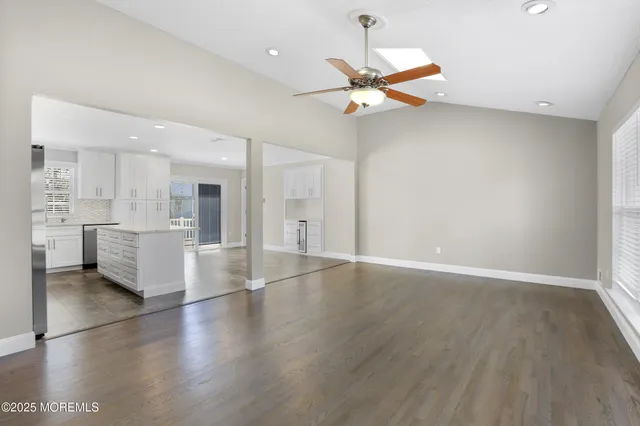 a view of a kitchen with a sink cabinets and a ceiling fan