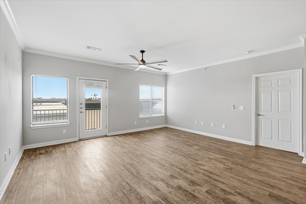 2502 Leon Street, Unit 414 Austin, TX 78705 - Photo 3 of 21 a view of an empty room with a window and wooden floor
