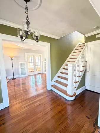 a view of an entryway with wooden floor