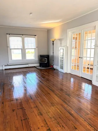 wooden floor in an empty room with a window