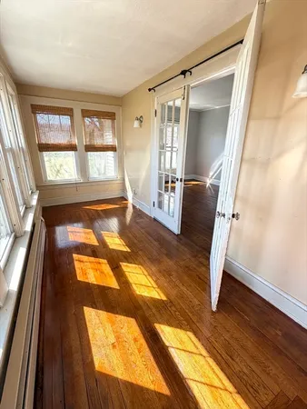 a living room with a couch and wooden floor
