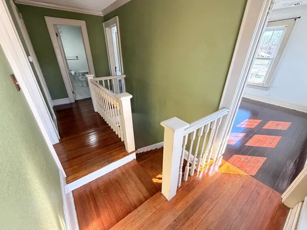 a view of an entryway with wooden floor