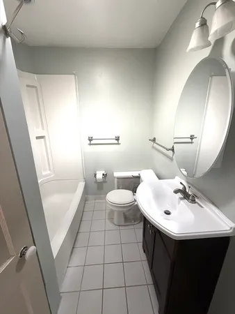 a bathroom with a sink a toilet and mirror