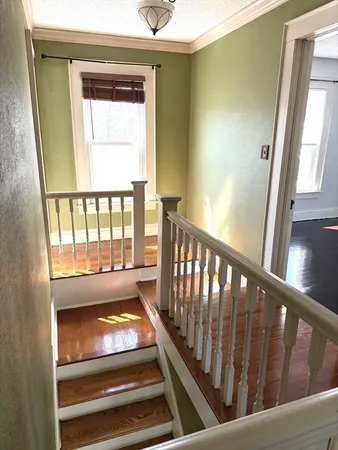 a view of an entryway with wooden floor