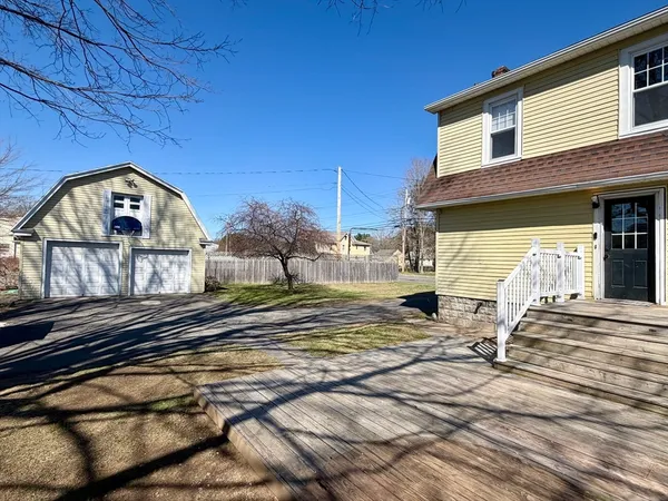 a view of a house with a wooden fence
