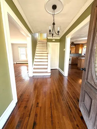 a view of a room with wooden floor and large windows