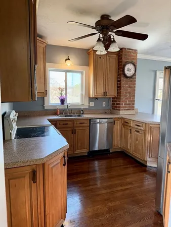 a kitchen with stainless steel appliances granite countertop a sink a stove and a wooden floors