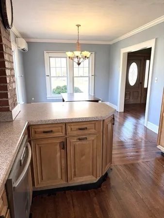 a view of a kitchen counter space and wooden floor