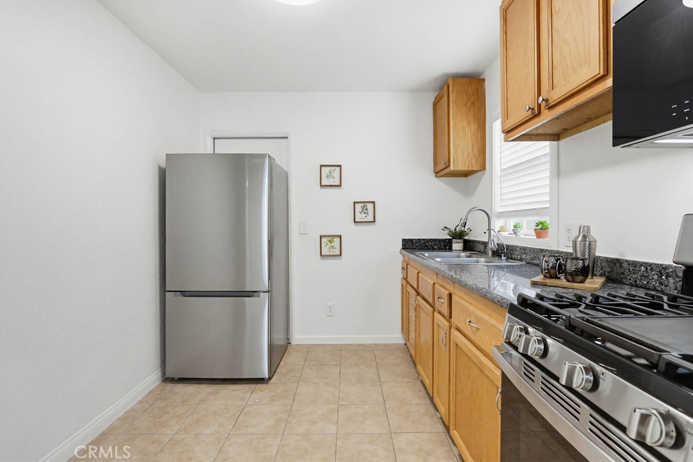 1104 Williamson Avenue Fullerton, CA 92833 - Photo 7 of 19 a kitchen with stainless steel appliances granite countertop a refrigerator and a stove top oven