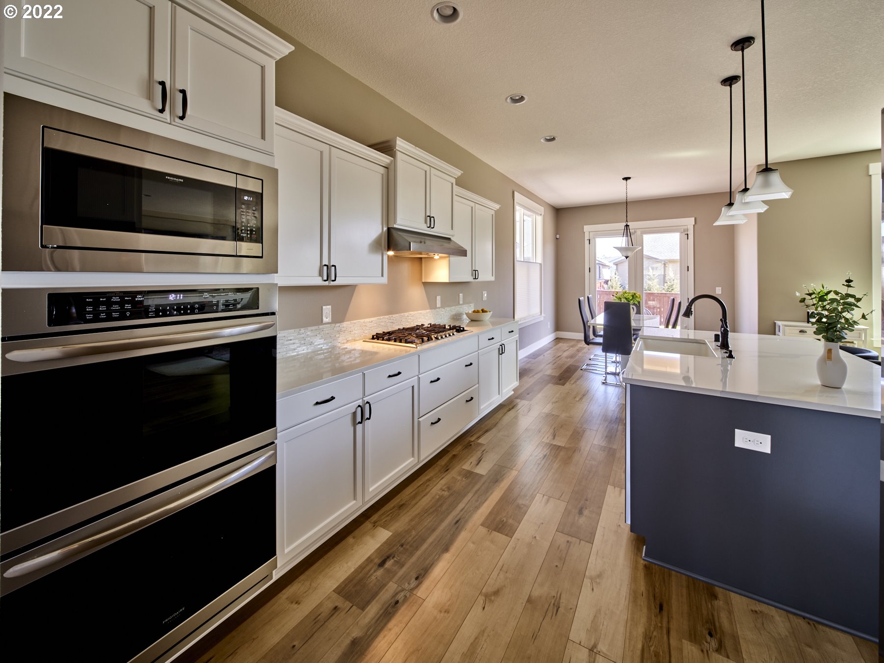 1638 South 46th Place Ridgefield, WA 98642 - Photo 6 of 29 a kitchen with stainless steel appliances kitchen island granite countertop a stove a sink and a microwave