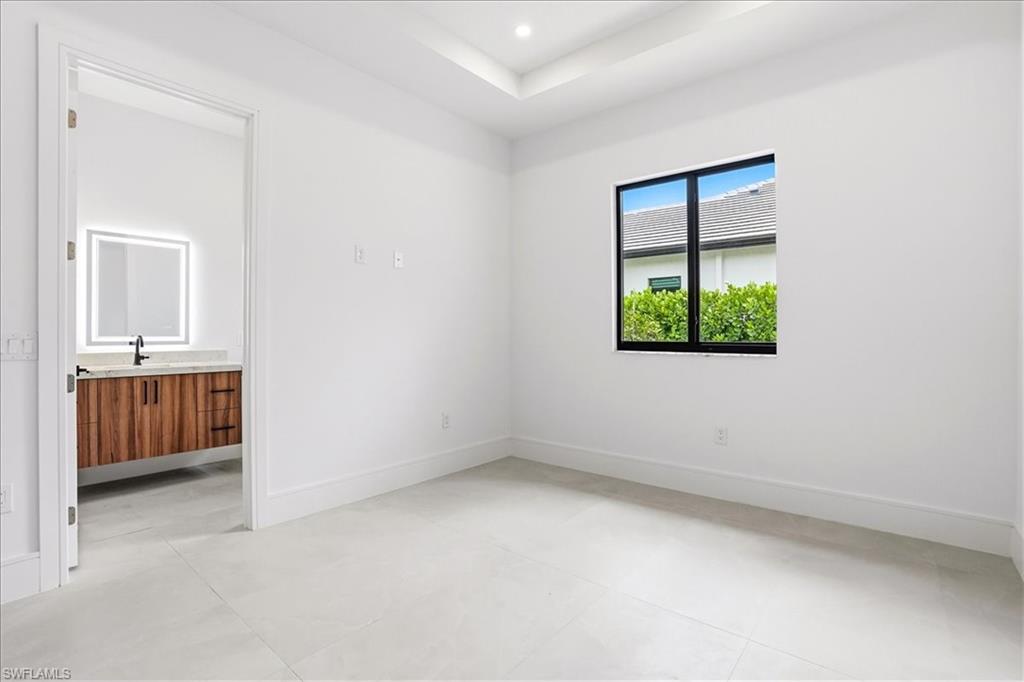 14318 Charthouse Circle Naples, FL 34114 - Photo 17 of 36 an empty room with a bathroom and a window