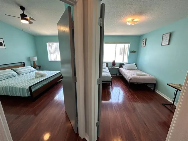 a bedroom with a bed and wooden floor