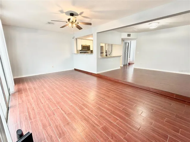 wooden floor in an empty room with a window