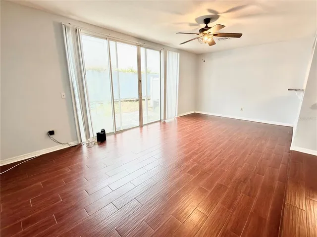 wooden floor in an empty room with a window