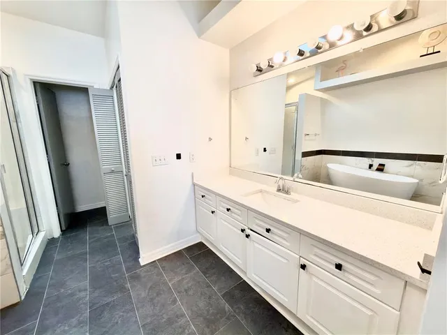 a bathroom with a double vanity sink and mirror