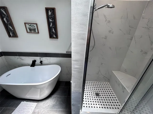 a bathroom with a bathtub and shower