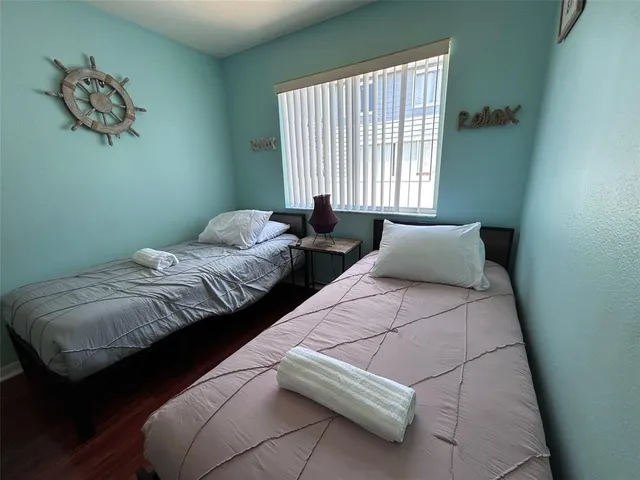 a bedroom with bed and a window
